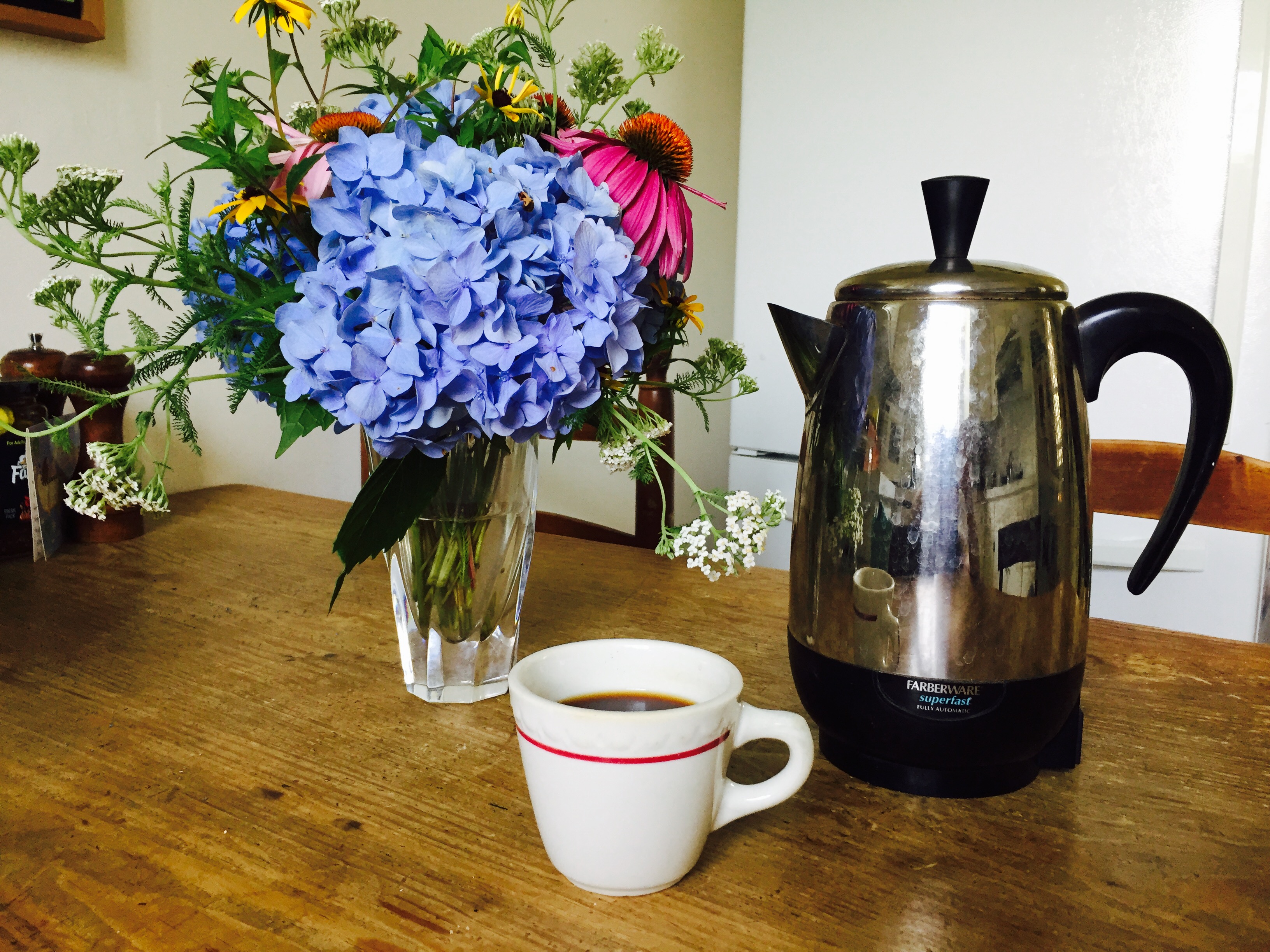 coffee percolator with retro cup and homegrown bouquet